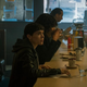 Elliot Page as Viktor Hargreeves sitting at a diner counter
